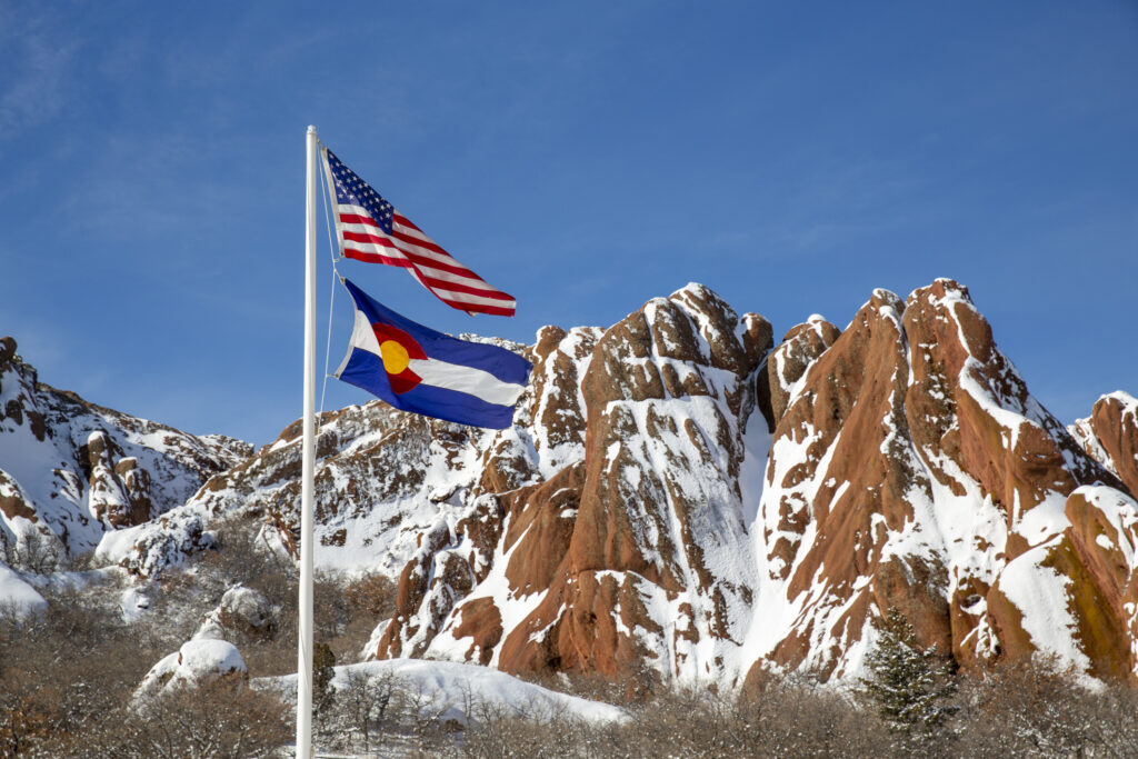 US flag in front of red rock